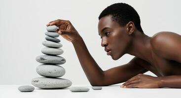 Focused Black Woman Building a Stone Tower. A Study in Balance and Mindfulness photo