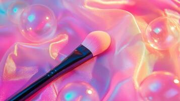 A makeup brush with large bubbles around it, against neon pink fabric. 5 photo