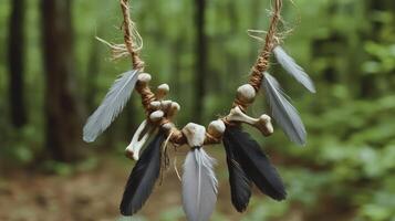 The necklace with weathered bones and dull gray feathers against a forest background. 12 photo