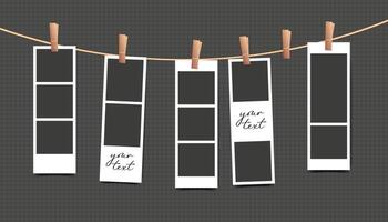 Blank photo booth stripe frame of set hanging on rope on black background vector