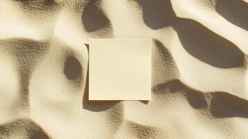 A blank square card on the sand, with shadows and ripples of sunlight. 6 photo