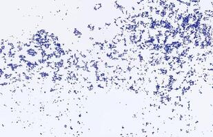 Blue speckled pattern on a white surface, creating an abstract and textured background effect. vector