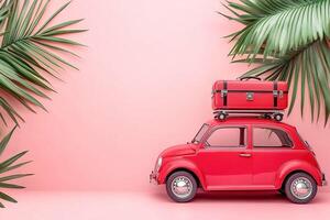 close-up little red retro toy car with luggage surrounded by green palm leaves on light pink background with copy space summer vacation traveling concept photo