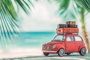 summer vacation travel image little red retro toy car with luggage on blurred sea beach background surrounded by palm leaves with copy space photo