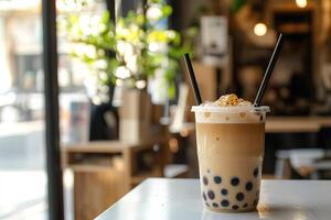 close-up of a glass of sweet tasty bubble tea with tapioca placed on the table in cafe with blurred background photo