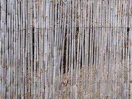 old weathered eco-friendly reed fence texture background photo