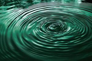 abstract calm background ripples spread out around the green clear water photo