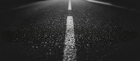 Black asphalt road with lane divider line leading forward background wallpaper. Copy space photo