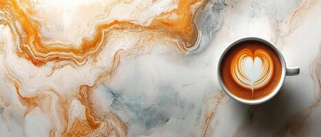 Top View of Warm Latte with Heart Foam on Abstract Marble Background photo