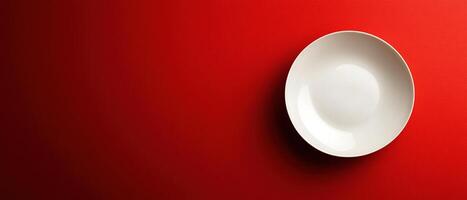 Minimalist White Plate on Bold Red Background with Copy Space photo