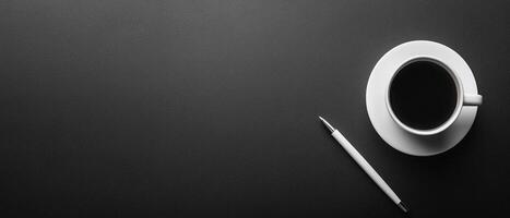 Top View of Elegant Workspace with Black Background White Cup of Coffee and Pen photo