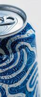 Highlighting a white beer can, this close-up showcases an elaborate blue design that captures the viewer's attention. The can is positioned against a light backdrop for contrast photo