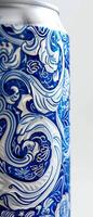 Detailed design of a white beer can highlights flowing blue patterns that create an artistic and captivating appearance, likely placed on a light background photo