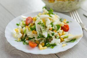 Vegetables in recipes. fresh salad with squid, eggs, tomatoes and other vegetables photo