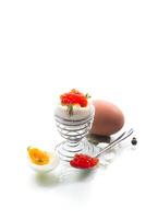 delicacy with red caviar and boiled egg for breakfast, isolated on white background photo