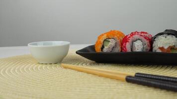 Colorful sushi rolls with chopsticks on elegant table setting video