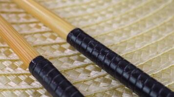 Intricate patterns and texture of artistic chopsticks on woven mat video