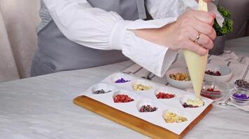 Filling out forms in the form of a heart with colorful ingredients, liquid white chocolate video