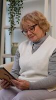 Sad elderly woman looking at an old photo with nostalgia video