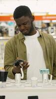 Man testing a new smartphone in an electronics store video