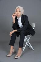 Full Body Portrait of Young Female in a Hijab Posing with Chair Isolated Background photo