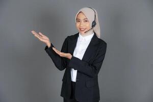 Young Female Customer Service Representative Agent in a Hijab Presenting or Explaining Isolated Background photo
