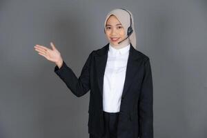 Young Female Customer Service Representative Agent in a Hijab Presenting or Explaining Background photo