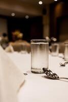 Glass of cool water on the table setting in the event photo