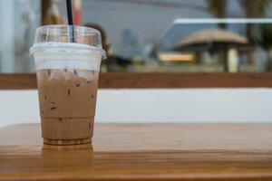 Preferred drink from menu iced mocha in plastic cup on table photo