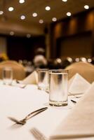 Glass of cool water on the table setting in the event at hotel photo