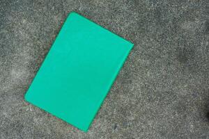 Black green leather notebook or diary on stone background photo