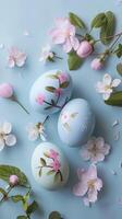 Three easter eggs with flowers on a blue background photo