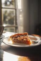 A slice of pie on a plate on a table photo