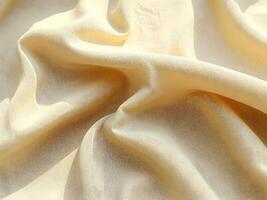 Abstract ink splashes on cream fabric, featuring bold black spots, fluid drips, and dynamic wrinkled texture. photo