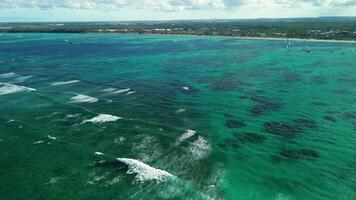 Aerial flight above the public Bavaro beach with white sand. Turquoise water of the Caribbean sea and tourist yachts and boats. Punta Cana, Dominican republic video