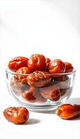 A bowl of tomatoes on a white surface photo