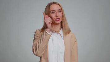 Woman pointing to camera and looking with playful happy expression, making choice, showing direction video