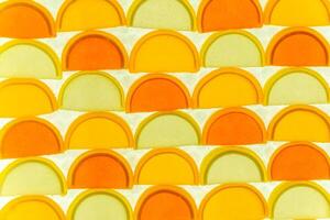 A colorful pattern of semicircles of oranges and lemons. photo