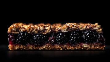 A blackberry and granola bar on a black background photo