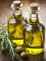 Two bottles of olive oil with olive leaves photo