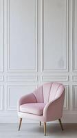 A pink chair in front of a white wall photo