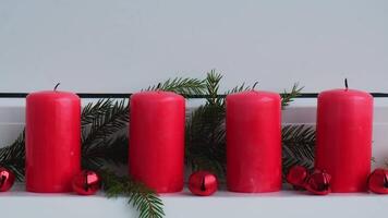New year and Christmas preparation. Four red advent candles burning in white windowsill. Handmade eco-friendly decor. Sustainable Christmas decoration atmosphere video