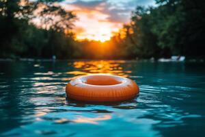 Floating Orange Ring Buoy in a Serene River at Sunset Surrounded by Lush Green Trees photo