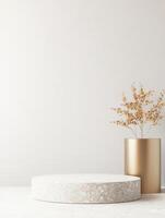Minimalist stone platform with golden vase and dried plant against neutral backdrop for display photo