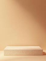Minimalist display platform against a textured peach-colored backdrop in a studio setting photo
