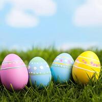 Easter eggs on green grass and the sky on the background. Easter background with copy space, and pastel colors. photo