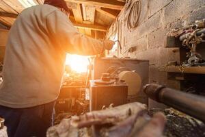 Elderly Craftsman Working in a Rustic Workshop photo