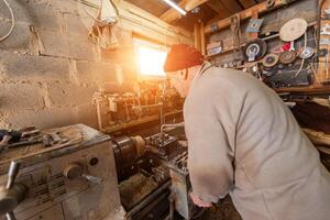 Elderly Craftsman Working in a Rustic Workshop photo