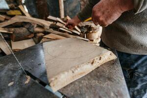 Carpenter Cutting Wood with a Bandsaw in a Rustic Workshop photo