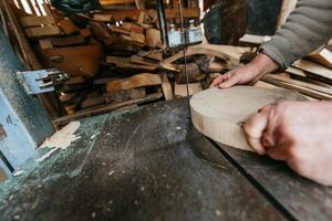 Carpenter Cutting Wood with a Bandsaw in a Rustic Workshop photo